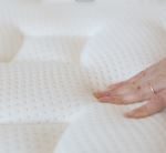 hand touching a mattress